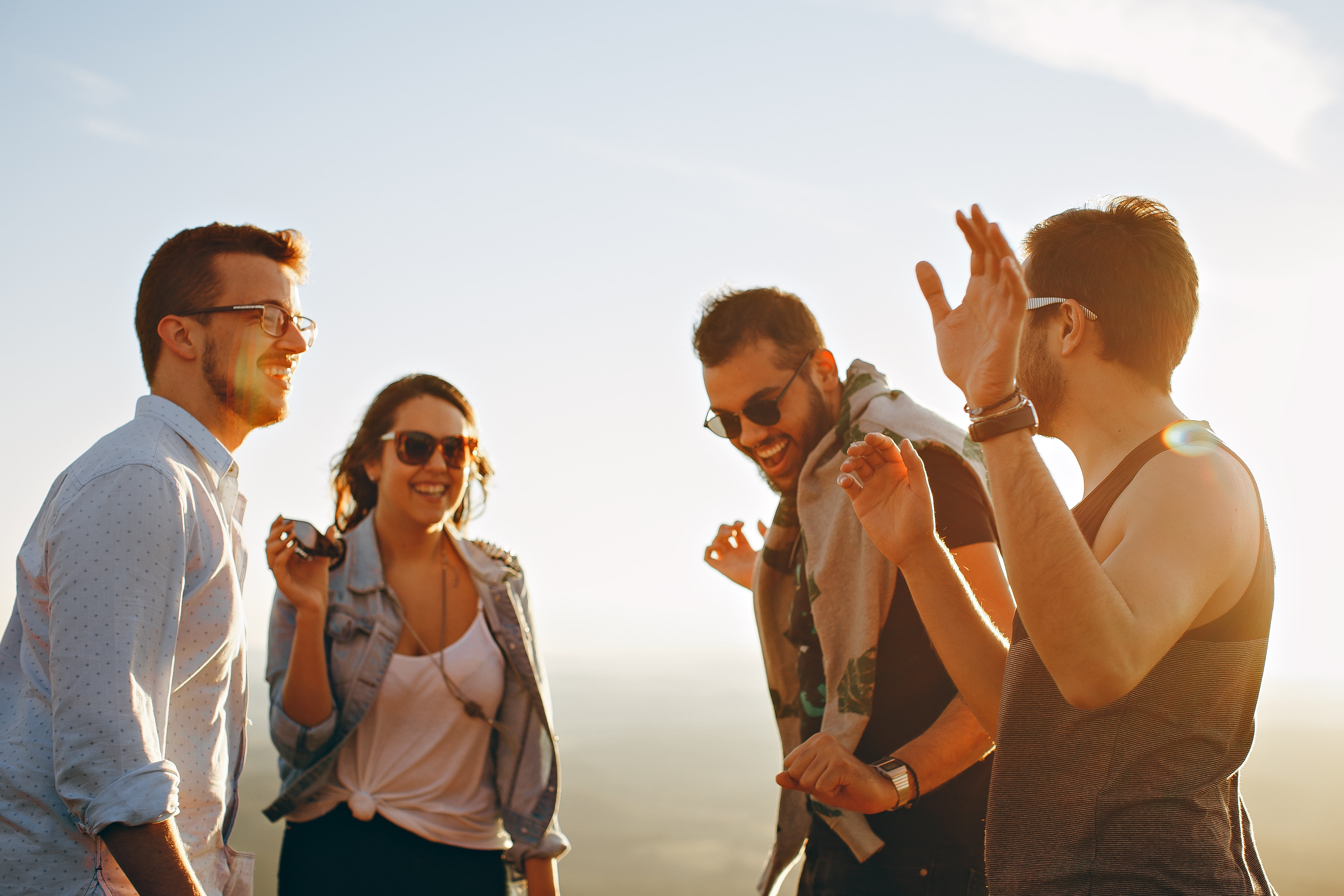 A group of friends dancing after successfully managing to get rid of debt.