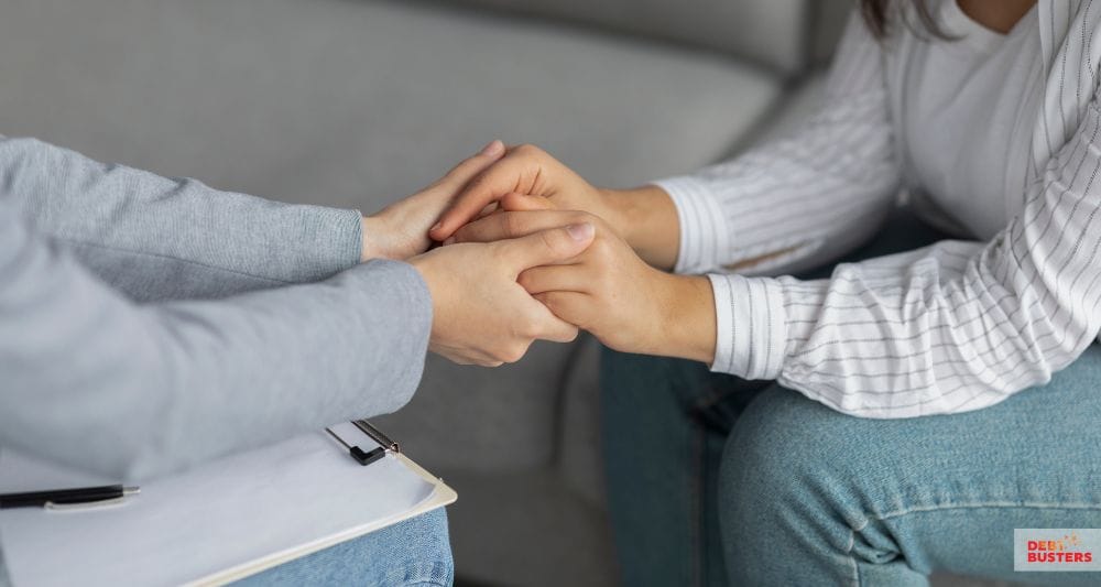 Supportive hands during a discussion about crisis loan for rent arrears eligibility and help.